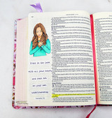 Card laid on an open Bible with the praying girl and the my-heart-trusts scripture.