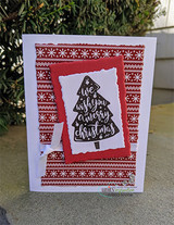 Card with the lettered Christmas tree on a torn white panel over red Nordic snowflake paper.