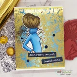 Gold-embossed paisley card with the heart-bun girl in a blue turtleneck and 'don't regret the past, learn from it.' on black label strips.