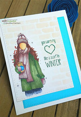 Angie Blom's AngieGirl bundled in a scarf and hat holding a hot drink with 'Happiness, pure and simple,' a red rubber winter stamp on a card.