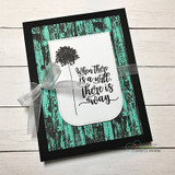 Black card with a teal woodgrain panel, a dandelion puff and the sentiment 'When there is a will, there is a way'