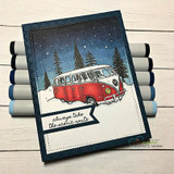 Handmade card featuring the vintage camper van among snowy pine trees, a red van on a dark stitched frame, stamped with 'Merry Christmas'.