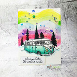 Handmade card featuring the vintage camper van among snowy pine trees, a teal van over a rainbow sky, stamped with 'A little Christmas cheer'.