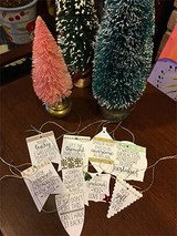 Cluster of banner tags stamped with the funny gift sentiments hung on twine.