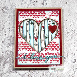 Red card with a heart aperture filled with blue-washed birch trunks over heart-print paper, and 'i love you' on a teal strip.