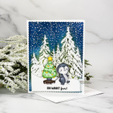 Snowy woodland scene card with a penguin decorating a little tree and 'Oh what fun!'