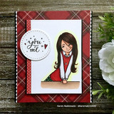 Red plaid and dotted card with a white panel, the girl colored in a grey cardigan and red skirt, and a stitched circle reading you + me = heart.