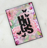 Pink floral card with big black die-cut HUGS and butterflies