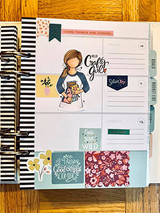 Planner spread with the crafty girl colored in a blue top: 'Hello crafty girl.'