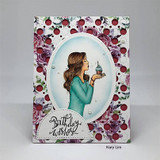Card with the woman in teal holding a cupcake framed by a wine-and-berry floral oval.