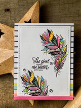 White card on a striped panel over pink and rainbow layers, two feathers stamped and colored in pink, teal, gold and purple, with the script sentiment "The good things are better with you."