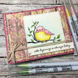Card with plum patterned paper and a stitched frame: the bird colored pink and yellow beside “The beginning is always today,” markers alongside.