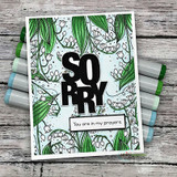 Card with a green-and-white lily-of-the-valley background layered under bold 'SORRY' letters and 'You are in my prayers.'