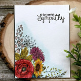 Handmade card featuring the lush corner spray of poppies, sunflowers and greenery, framing a soft watercolor card, stamped with 'With deepest sympathy'.