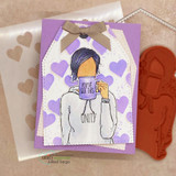 Purple heart-print card of the AngieGirl sipping from a mug.