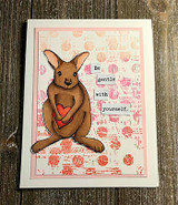 Card of a brown kangaroo holding a red heart on a pink script panel with "Be gentle with yourself."