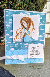A soft blue cloud print card with the girl in a pale blue dress, above a small panel reading 'you are more than beautiful'.