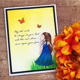 Card of the girl in a blue-and-yellow dress against a golden sky with butterflies.