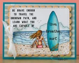 Coral and teal card with a peach scalloped mat, the girl in pink beside a blue surfboard stamped 'live. breathe. surf.', and 'Be brave enough to travel the unknown path, and learn what you are capable of'.