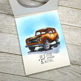 Card with a rust-brown Scout SUV against a blue sky and 'Life is either a great adventure or nothing.'