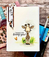 A cute baby giraffe hand-stamped on a card and lettered "Thanks for being you."