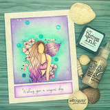 Card with the mermaid in purples and greens with seashells, 'wishing you a magical day.'