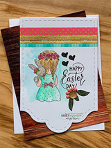 Card with the girl in a mint dress holding the bunny, with coloured leaves and berries, on a scalloped white panel over striped and wood papers, sentiment "HAPPY Easter DAY."