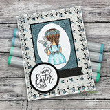 Card with the girl and bunny coloured with a blue polka dot dress and floral crown in an oval frame over speckled paper, with a "HAPPY Easter DAY" circle.