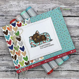 Card of the puppy over rainbow hearts with a soft frame.