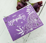Purple card with the flowers stamped in white, finished with a bold 'DEEPEST sympathy.'