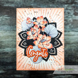 Bold orange sunburst card with the lotus colored coral over a black mandala die-cut and a 'Congrats' banner.