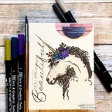 Cream card styled with alcohol markers and a pen, the sketched unicorn coloured in soft browns and purples, sentiment 'YOU ARE Beautiful'.