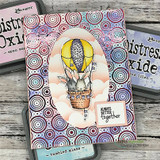 Card with a purple and teal swirl-print background and an oval frame, the bunnies in a yellow balloon on a cloud, sentiment 'ALWAYS BETTER together', shown with distress inks.