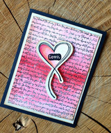 Handmade card featuring a flowing handwritten script background, with the sentiment "By His wounds we are healed."