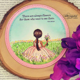 Card with the meadow girl in a pink dress on a wood-slice circle and the flowers sentiment.