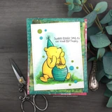 Handmade Winnie the Pooh card with Pooh and his honey pot, the sentiment 'Sweet little smiles on your birthday', layered on green and teal Magnolia Dreams papers.