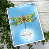 Golden dragonfly on a soft blue card, faith sentiment.