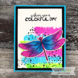 Purple and pink dragonfly on a bright colorblock card, 'wishing you a colorful day'.