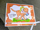 Orange paw-print card with the girl hugging a golden dog and 'Sending a big ol' hug your way.'