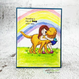 Card with the girl and golden dog under a rainbow, 'Sending a big ol' hug your way.'
