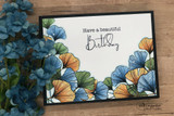 Black-framed card with blue and orange ginkgo leaves fanning around 'Have a beautiful Birthday'