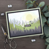 Handmade card with a stenciled cloud and sky background made using the stencil.