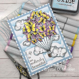 Handmade card with a stenciled cloud and sky background made using the stencil.