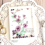 Shaker-style card of pink and purple poppies with 'Sending hugs' on a scalloped panel.