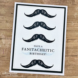 White card with four black mustaches stacked down the panel around the 'Have a fan{tache}tic birthday!' sentiment.