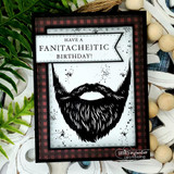 Card with the black stamped beard on a white panel framed in red and black buffalo plaid with ink splatters, under a 'Have a fan{tache}tic birthday!' banner.