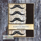 Card with three mustaches on a whitewashed woodgrain panel beside a dark brown strip, with a 'Have a fan{tache}tic birthday!' band.