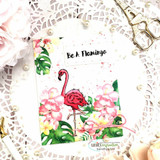 Card of a pink flamingo among tropical leaves and blooms with a "Be A Flamingo" tag.