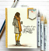 Handmade card featuring the autumn girl bundled in a coat and scarf holding a warm drink, on a soft floral fall background, stamped with 'Thoughts of you warm my heart'.