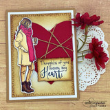 Handmade card featuring the autumn girl bundled in a coat and scarf holding a warm drink, matted with a red felt heart, stamped with 'Thoughts of you warm my heart'.